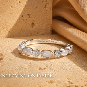 May include: A silver ring with a row of alternating oval and round gemstones. The ring has the inscription "Always with me" and a heart symbol. The words "Engraving on Inside" are at the bottom of the image.