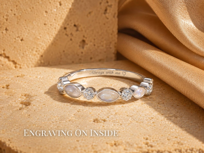 May include: A silver ring with a row of alternating oval and round gemstones. The ring has the inscription "Always with me" and a heart symbol. The words "Engraving on Inside" are at the bottom of the image.