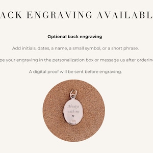 May include: Image shows a silver oval pendant with the words "Always with me" engraved on it, along with a small heart symbol. The pendant hangs from a small loop. Text above reads "Back Engraving Available" and describes engraving options.