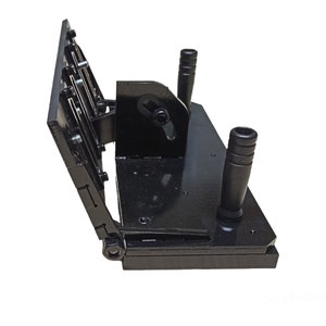 May include: A black metal tool with a hinged design. It features two vertical handles and a series of adjustable plates. The tool is designed for a specific mechanical purpose, with visible bolts and fasteners.