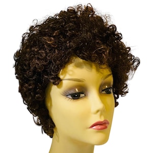 May include: A short, dark brown wig with tight, defined curls styled in a layered, voluminous cut. The wig is displayed on a pale, smooth mannequin head with neutral facial features, dark eyelashes, and glossy pink lips against a white background.