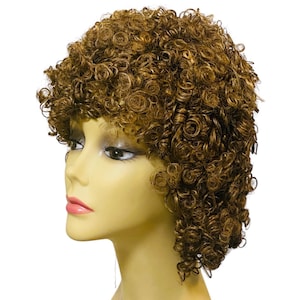May include: A short, curly wig in a medium brown shade with tight, defined ringlets. The hair is styled with volume around the crown and sides, framing the face of a mannequin head with pale skin, dark eyelashes, and soft pink lips.