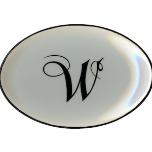 May include: A set of three ceramic mugs with a speckled, matte finish. The mugs are in shades of cream, light gray, and dark gray. Each mug has a simple, minimalist design, perfect for coffee or tea.