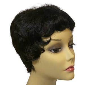 May include: A black, short-haired wig styled in a classic, wavy bob. The wig is displayed on a mannequin head with a neutral skin tone, showcasing the hair's texture and style. The wig's dark color contrasts with the mannequin's complexion, highlighting the hair's shape.