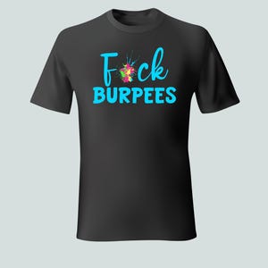 May include: Black t-shirt with the words "F*ck Burpees" in turquoise, with a colorful splatter design. The shirt is a crew neck style and appears to be made of a soft material.