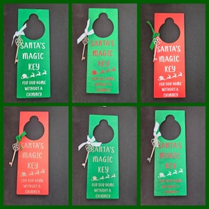 May include: Six wooden door hangers with a keyhole and a gold key. Each hanger has the text "Santa's Magic Key" and "For our home without a chimney". Three hangers are green and three are red.