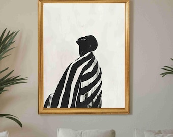 May include: A framed art print with a black and white abstract image of a person looking upwards, draped in a striped pattern. The artwork is above a cream-coloured sectional sofa in a living room setting.