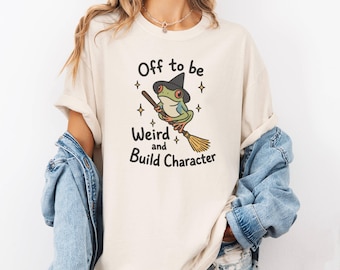 Off To Be Weird And Build Character Tshirt, Funny Frog in Witch Broomstick Shirt, Vintage Cottagecore, Quirky Retro Ren Faire Frog Tee
