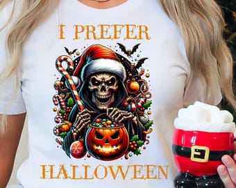 May include: White t-shirt with a Halloween-themed graphic. The design features a skeleton wearing a Santa hat, holding a candy cane and a jack-o'-lantern. The text "I PREFER HALLOWEEN" is printed above and below the graphic.