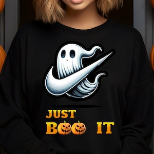 May include: Black sweatshirt with a white ghost graphic and the text "JUST BOO IT" in yellow. The ghost is wearing a white Nike swoosh.