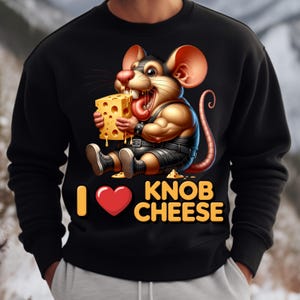 May include: Black sweatshirt with a cartoon mouse graphic. The mouse is holding a block of cheese and has the text "I ❤️ KNOB CHEESE" in yellow and red. The mouse is wearing a black outfit.