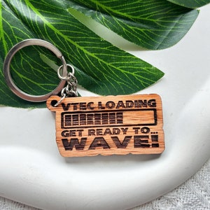 May include: Wooden keychain with a progress bar graphic that reads "VTEC LOADING GET READY TO... WAVE!"