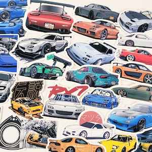 Könnte beinhalten: Eine Sammlung bunter Autoaufkleber mit verschiedenen Marken und Modellen. Die Aufkleber sind auf weißem Papier gedruckt und zeigen eine Vielzahl von Designs, darunter ein rotes Sportwagen, eine blaue Limousine und ein silberner SUV. Die Aufkleber sind perfekt, um Ihrem Auto, Laptop oder Ihrer Wasserflasche eine persönliche Note zu verleihen.