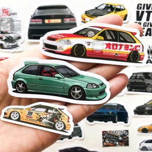 May include: A collection of colorful car stickers featuring Honda Civics. The stickers are printed on white paper and feature different designs, including a green Civic, a yellow Civic with the number 99, and a red Civic with Japanese text.