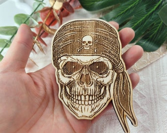 May include: A wooden pirate skull with a bandana, a skull and crossbones design, and a detailed facial expression.