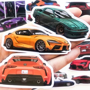May include: A set of colourful car stickers featuring different makes and models of sports cars. The stickers are printed on white paper with a glossy finish.