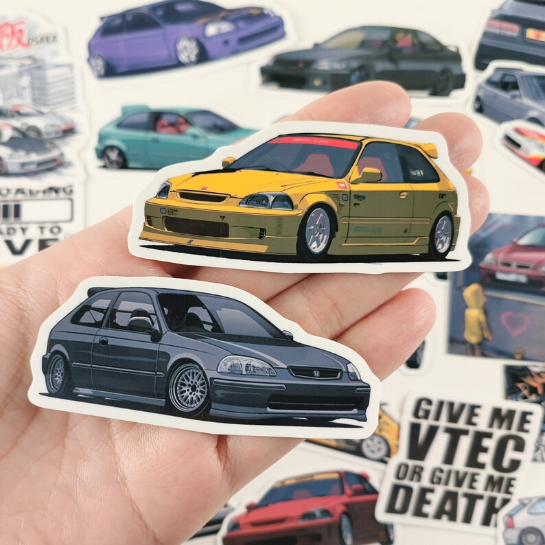May include: Two sticker designs of Honda Civic cars. The first sticker is yellow with a red stripe and black accents. The second sticker is gray with black accents. Both stickers have a white background.