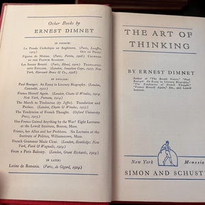 May include: Open book pages with text titled "THE ART OF THINKING" by Ernest Dimnet. The book's publisher is Simon and Schuster, New York. The left page lists other books by Ernest Dimnet.