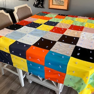 May include: A set of three ceramic mugs with a speckled, cream-colored glaze. Each mug features a different hand-painted floral design in shades of blue, green, and yellow. The mugs have a simple, rounded shape and a comfortable handle.