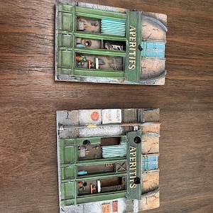 May include: A set of three ceramic mugs with a speckled, matte finish. The mugs are in shades of cream, light gray, and dark gray. Each mug has a simple, minimalist design and a rounded handle.