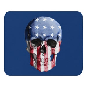 May include: A white skull with the American flag painted on it. The skull is on a blue background.
