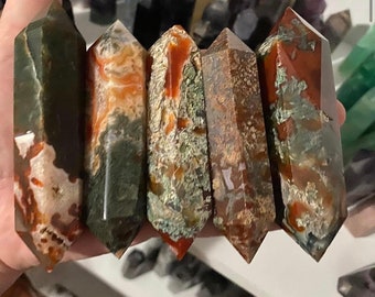 May include: Five red moss agate double terminated points, each with a unique pattern of red, green, and white. Red Moss Agate DT $14 each.