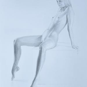 May include: A graphite pencil drawing on paper depicting a figure seated on a cube. The figure has long hair, is shown in a side profile view, and is leaning back with one arm extended behind for support. The shading creates depth and form.