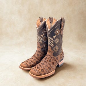May include: A pair of brown leather cowboy boots with intricate geometric patterns and stitching. The boots have a square toe, a stacked heel, and a tall shaft with decorative embroidery. The color palette includes shades of brown and tan.