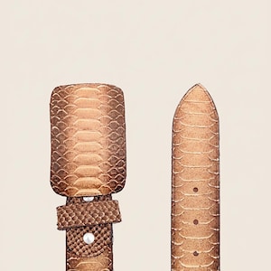 May include: A brown leather belt with a snakeskin pattern. The belt has a rectangular buckle and a pointed end with several holes. The belt is a neutral color and would be suitable for many outfits.