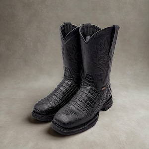 May include: A pair of black cowboy boots with a textured, crocodile-like pattern on the foot and a smooth leather upper. The boots have a classic western design with decorative stitching and a square toe.