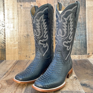 May include: A pair of black cowboy boots with a snakeskin pattern and intricate embroidery on the shaft.