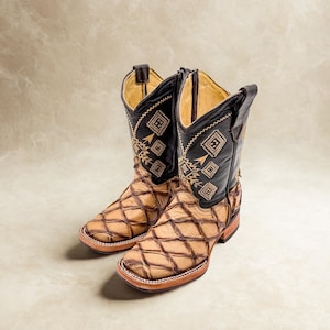 May include: A pair of cowboy boots with a fish scale pattern on the foot and a black leather upper with embroidered details. The boots have a square toe and a stacked heel, showcasing a classic Western style.