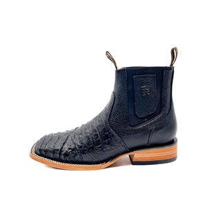 May include: Black leather ankle boots with a square toe and a textured, crocodile-like pattern. The boots have a pull tab and a light brown sole. The heel is approximately 1 inch high.