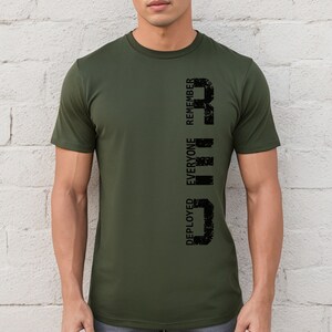 May include: A green t-shirt with a black vertical graphic that reads "DEPLOYED EVERYONE REMEMBER".