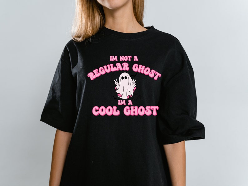 May include: Black t-shirt with a pink graphic of a ghost with the text "I'm not a regular ghost, I'm a cool ghost."