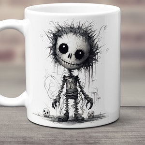 May include: White ceramic mug with a black and white illustration of a cartoon skeleton character with a stitched-up body and a toothy grin. The character is surrounded by small skulls.