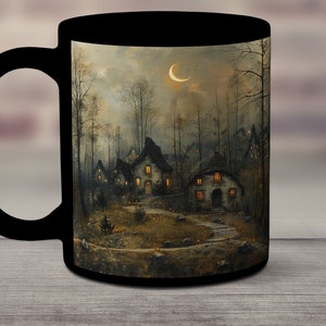 May include: Black coffee mug with a whimsical illustration of a small village nestled in a forest under a crescent moon. The houses have glowing windows and a path leads to the center of the village.