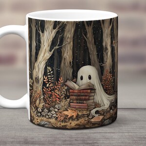 May include: White ceramic mug with a spooky illustration of a ghost reading a stack of books in a dark forest. The ghost is white and has two black eyes. The forest is dark and has brown trees and leaves. The mug is a great gift for Halloween or for anyone who loves to read.