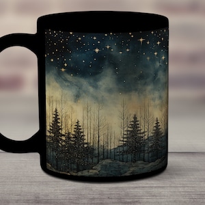 May include: Black ceramic mug featuring a forest scene under a starry night sky. The design includes silhouetted trees and a gradient of colors from dark blue to gold. The mug has a large handle.