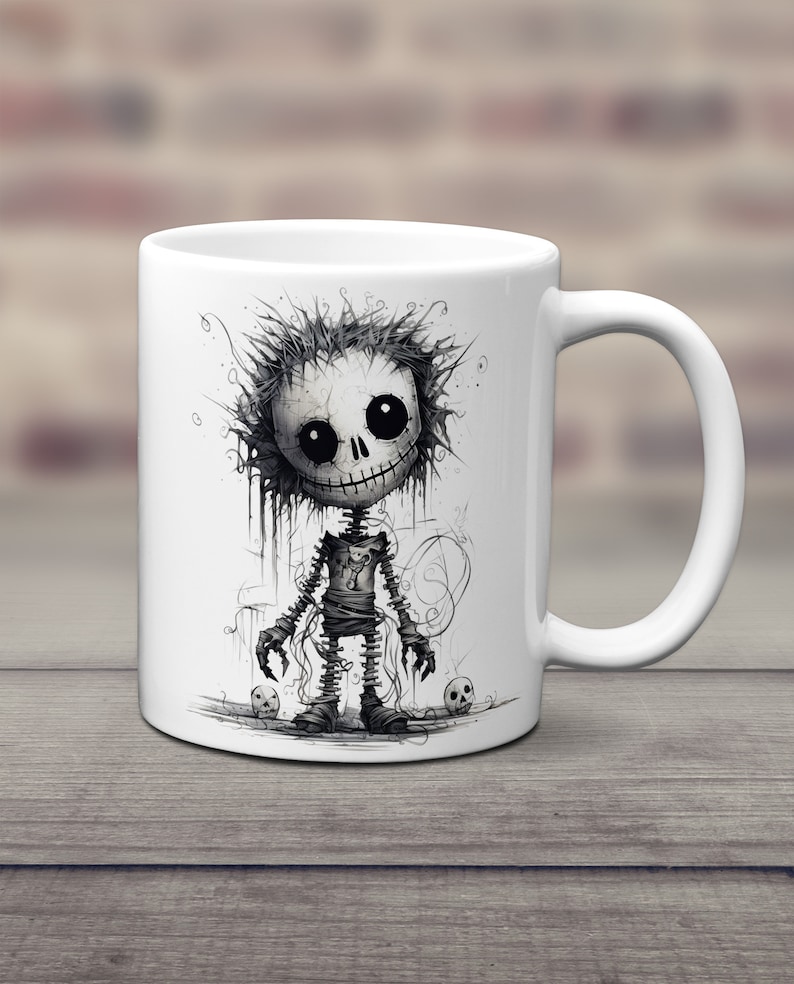May include: White ceramic coffee mug with a black and white illustration of a cartoon skeleton with a stitched-up body and a creepy smile. The skeleton is surrounded by skulls.