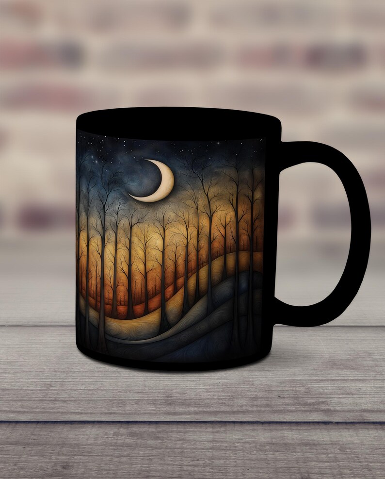 May include: Black ceramic coffee mug with a crescent moon and a forest scene in shades of orange, brown, and blue.