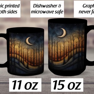 May include: Two black ceramic mugs with a forest scene and crescent moon design. The mug on the left is 11 oz and the mug on the right is 15 oz.