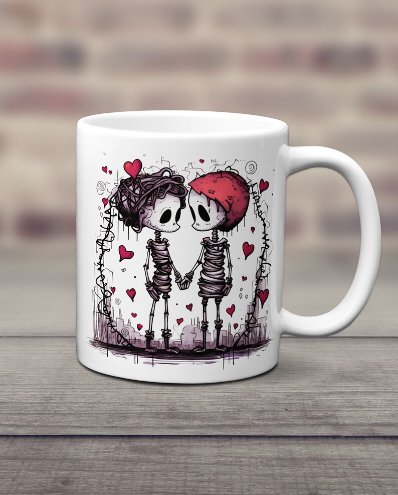 May include: White ceramic mug with a graphic of two skeletons holding hands. The skeletons are wrapped in bandages and have red hearts around them. The mug is a great gift for couples.