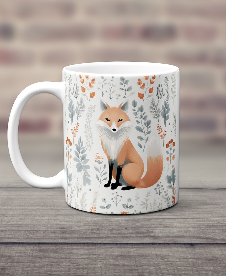 May include: White ceramic mug with a fox illustration surrounded by a floral pattern in shades of orange, blue, and green.