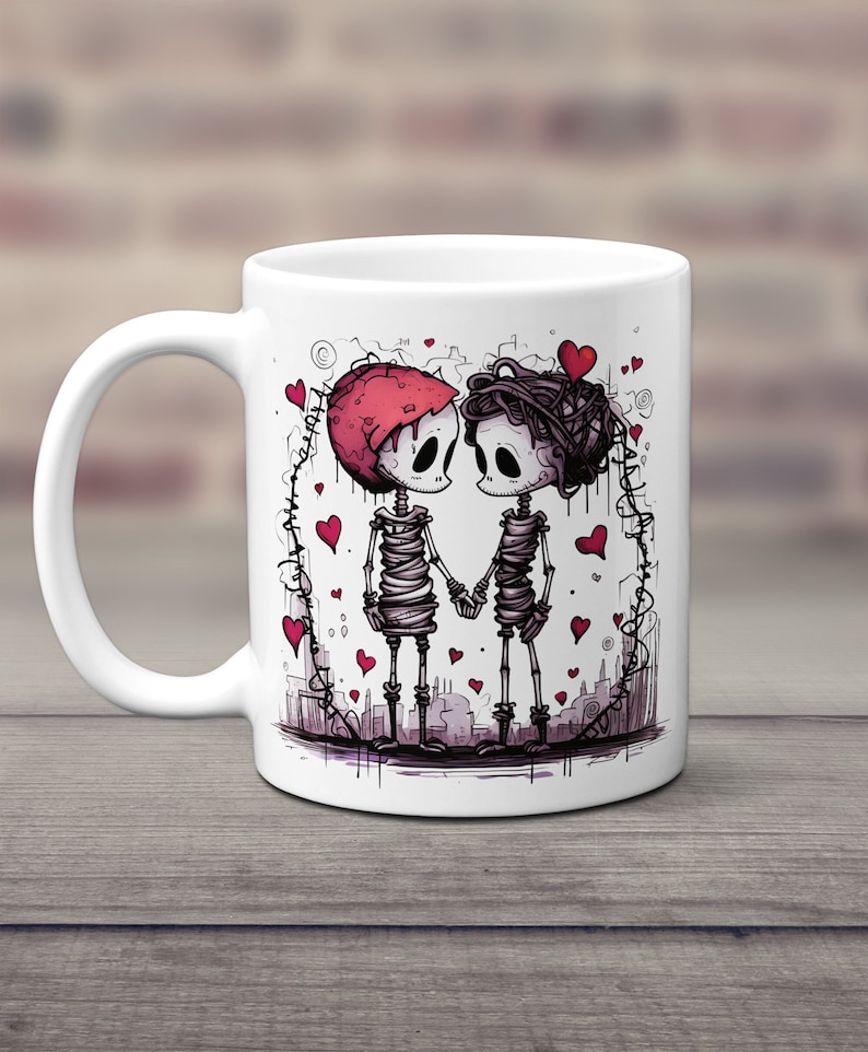 May include: White ceramic mug with a graphic of two skeletons holding hands. The skeletons are wearing red hearts and are surrounded by a cityscape. The mug is a great gift for couples.