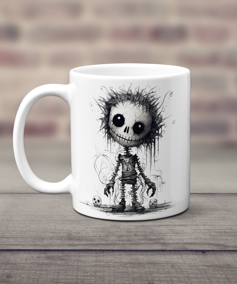 May include: White ceramic mug with a black and white illustration of a cartoon skeleton character with a stitched-up body and a toothy grin. The character is surrounded by small skulls.