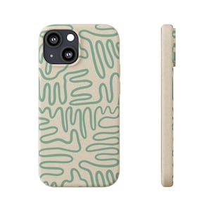 May include: A beige phone case with a green abstract pattern. The case has a cutout for the camera lens.