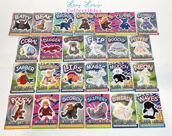 May include: A set of 24 colorful trading cards featuring various Beanie Babies characters. Each card has a different character with a name and a glow-in-the-dark sticker. The cards are arranged in four rows of six cards each.