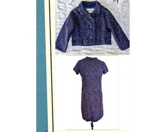 May include: A vintage blue tweed jacket and dress set. The jacket has a button closure and a collar. The dress is short-sleeved and knee-length. Both pieces have a textured weave with blue, purple, and black threads.