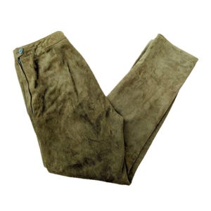 May include: Olive green suede pants with a button and zipper closure. The pants are folded and displayed on a white background. The pants have a classic, straight-leg design.